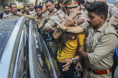 Police intervene as lawyers trash accused Sahil Shukla while he was being produced in a court in connection with Merchant Navy officer Saurabh Rajput's killing, in Meerut, Wednesday, March 19, 2025.