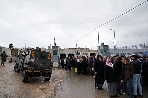 Palestinians lineup to cross from the Israeli military Qalandia checkpoint near the West Bank city of Ramallah to Jerusalem, to participate in the Friday prayers at the Al-Aqsa Mosque compound during the Muslim holy month of Ramadan on Friday, March 21, 2025.