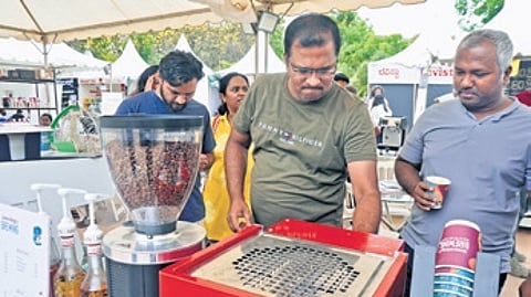 People check a stall at the Coffee Santhe at Freedom Park.