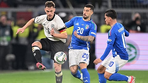 Germany's defender #06 Joshua Kimmich, Italy's forwards #20 Mattia Zaccagni and Giacomo Raspadori vie for the ball during the UEFA Nations League quarter-final second leg football match between Germany and Italy on March 23, 2025.