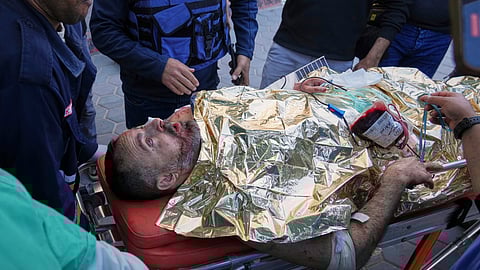 An injured United Nations Mine Action Service (UNMAS) worker is brought into al-Aqsa Martyrs Hospital following what the U.N. described as a strike in which an explosive ordnance was "dropped or fired" in Deir al-Balah, central Gaza, Wednesday, March 19, 2025.