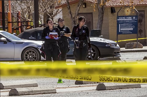 Crime scene technicians investigate the parking lot at Young Park after Friday night's fatal shooting in Las Cruces, N.M., on Saturday, March 22, 2025.