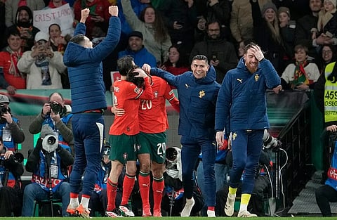 Portugal's Francisco Trincao, center, celebrates with teammates after scoring his side's fourth goal during the UEFA Nations League soccer match between Portugal and Denmark on Sunday, March 23, 2025.