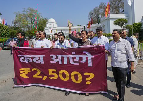 Leader of Opposition in Delhi Assembly Atishi with other AAP MLAs holds a protest alleging non-implementation of Mahila Samman Yojana on the first day of the Budget session, in New Delhi, Monday, March 24, 2025.