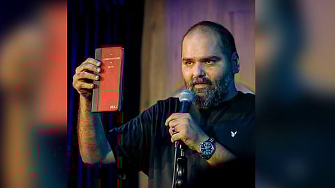 Comedian Kunal Kamra holds a copy of the Indian Constitution during a stand-up show in Mumbai.