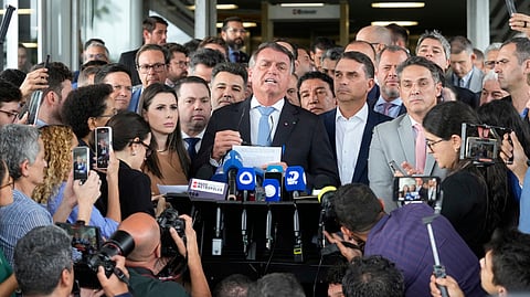 Brazil's former President Jair Bolsonaro speaks to the press at Congress in Brasilia, Brazil, Wednesday, March 26, 2025, after a panel of Brazil Supreme Court justices accepted charges against him over an alleged attempt to stay in office after his 2022 election defeat.