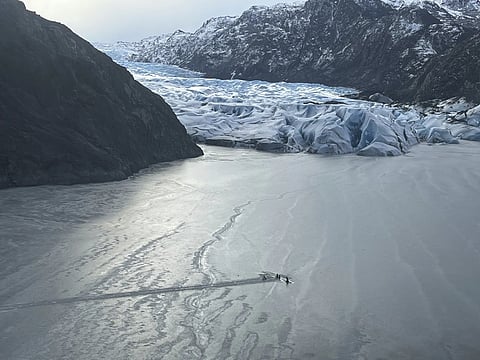 This photo provided by the Alaska National Guard shows an airplane partially submerged into the ice of Tustumena Lake at the toe of a glacier on Monday, March 24, 2025, near Soldotna, Alaska.