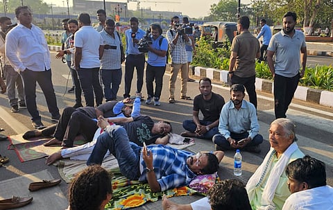 Congress MLAs Tara Prasad Bahinipati, Ramesh Jena and other party workers sleep on the road in protest against suspension of party's 12 MLAs for 7 days in the ongoing Budget Session of Odisha Assembly, in Bhubaneswar, Wednesday, March 26, 2025.