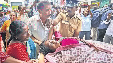 K P Thankamani, an ASHA worker who was on hunger strike, being shifted to hospital on Wednesday. The indefinite hunger strike demanding a rise in honorarium entered the seventh day on Wednesday