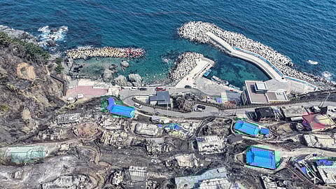 Burnt-out houses are seen at a damaged village due to wildfires in Yeongdeok, South Korea, Wednesday, March 26, 2025