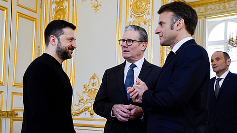 Ukraine's President Volodymyr Zelenskyy, left, French President Emmanuel Macron, right, and Britain's Prime Minister Keir Starmer speak during a trilateral meeting on the sidelines of a summit for "coalition of the willing" at the Elysee Palace, Thursday, March 27, 2025.