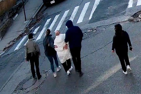 In this image taken from security camera video, Rumeysa Ozturk, a 30-year-old doctoral student at Tufts University, is detained by Department of Homeland Security agents on a street in Sommerville, Mass., Tuesday, March 26, 2025.