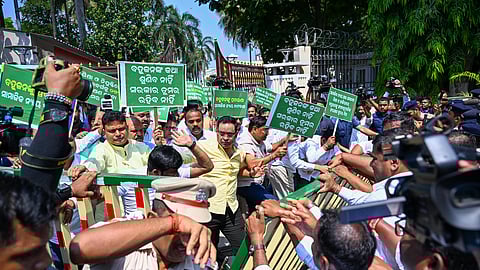 BJD MLAs trying to force their way out of the Assembly gate to garland the statue of BR Ambedkar at AG Square, in Bhubaneswar on Wednesday.