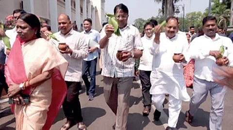 BJD MLAs walk with pots of Ganga Jal and mango leaves to conduct purification of the Assembly.
