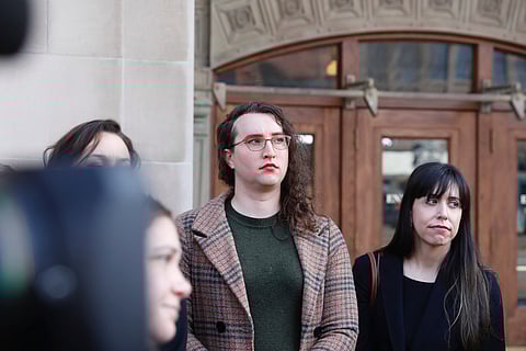 U.S. Army Sgt. 1st Class Sierra Moran, a transgender service member, listens during a press conference in Tacoma, Wash., on Tuesday, March 25, 2025.