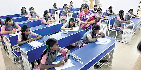Students writing the public exam at government girls higher secondary school in Ashok Nagar on Friday.