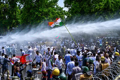 Water canons sprayed at congress workers during a protestors to gherao state assembly while demanding for House Committee formation to address growing crimes against women at Mahatma Gandhi Marg in Bhubaneswar on Thursday.