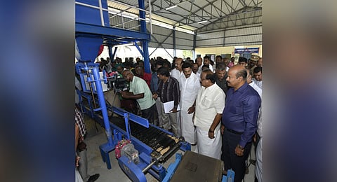 Food and Civil Supplies Minister R Sakkarapani (second from right) inspecting an equipment at the mega DPC at Panchanathikkottai in Thanjavur district after inaugurating the centre on Saturday