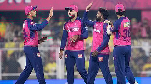 Rajasthan Royals' Wanindu Hasaranga, second right, celebrates with teammates after the dismissal of Chennai Super Kings' Rahul Tripathi during the Indian Premier League cricket match between Chennai Super Kings and Rajasthan Royals at Barsapara Cricket Stadium in Guwahati, India, Sunday, March 30, 2025.