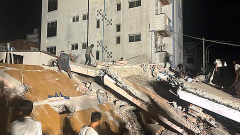Volunteers work at the site of a building that collapsed after an earthquake in Mandalay, central Myanmar, Saturday, March 29