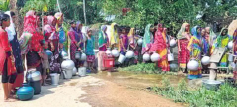 Women and kids standing in queue near a tubewell at a village in Mahakalapada