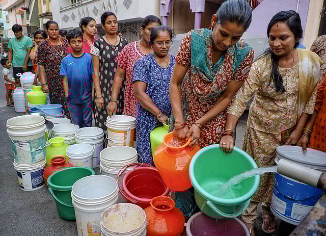 Women queue up to fill water.