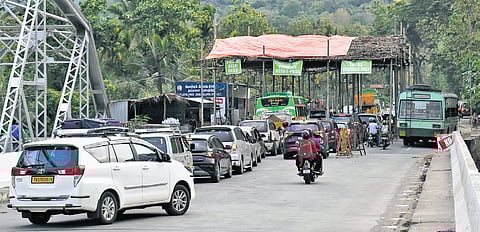 Officials checking e-pass of vehicles heading to the Nilgiris district