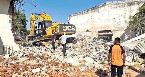 Debris being removed after massive blaze triggered by blast in firecracker unit.