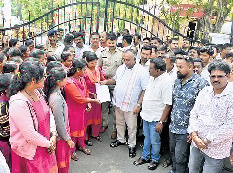 BJP MLA TS Srivatsa meets the workers at the KSIC factory in Mysuru on Tuesday