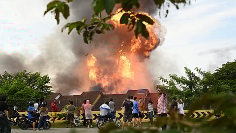 Residents watch a colossal fire erupt due to a burst gas pipe in Putra Heights in central Selangor state, Malaysia, Tuesday, April 1.