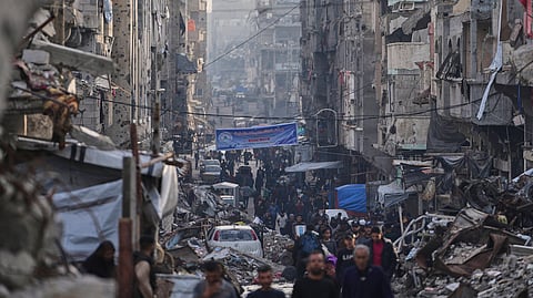 Palestinians walk through Al-Shati camp, Gaza City, Tuesday, March 25, 2025.