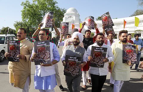 AAP MLAs stage a protest over the alleged power cuts in several areas of the national capital, during the Budget session of Delhi Assembly, in New Delhi, Tuesday, April 1, 2025.