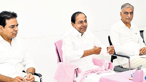 BRS president and former chief minister K Chandrasekhar Rao with KT Rama Rao (L) and T Harish Rao (R)