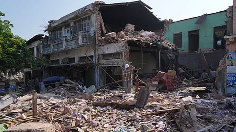 People inspect their homes, damaged following Friday's earthquake in Naypyitaw, Myanmar, Tuesday, April 1, 2025.