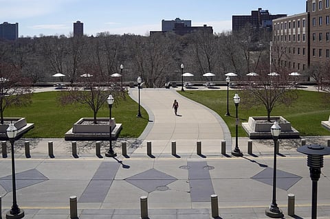 A person walks on campus at University of Minnesota in Minneapolis on April 21, 2020.