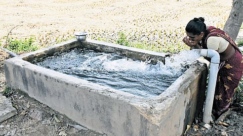 A woman seen quenching her thirst from an agricultural bore during the hot summer in Tirupati on Wednesday.