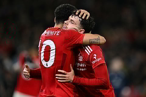Nottingham Forest's midfielder #10 Morgan Gibbs-White (L) and defender #07 Neco Williams react after the English Premier League football match between Nottingham Forest and Manchester United at The City Ground in Nottingham, central England, on April 1, 2025.