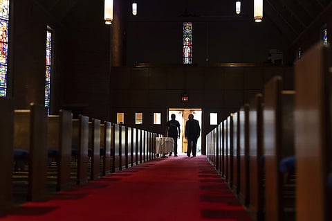 The Rev. W. J. Mark Knutson, right, walks with an El Salvadoran immigrant at the Augustana Lutheran Church on Thursday, Jan. 9, 2025, in Portland, Oregon.