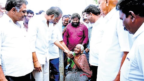 Minister Gottipati Ravi Kumar handovers pension at Bhagavan Raju palem village on Tuesday.