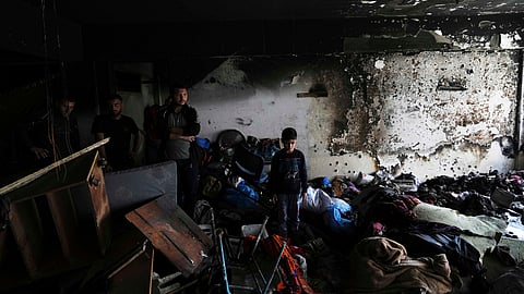 Palestinians inspect a UN building after it was hit by an Israeli strike, in Jabaliya, northern Gaza Strip, on Wednesday, April 2, 2025.