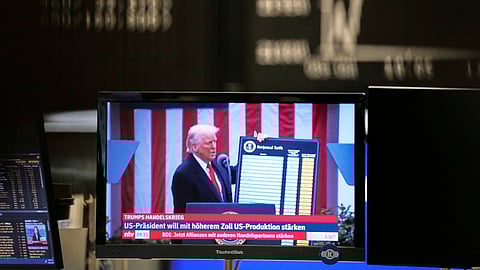 US President Donald Trump appears on a television screen at the stock market in Frankfurt, Germany, Thursday, April 3, 2025.