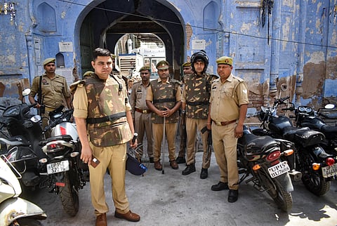 Police personnel stand guard after the passage of the Waqf Amendment Bill in the Parliament amid tight security, near Jama Masjid in Meerut, Uttar Pradesh, Friday, April 4, 2025.