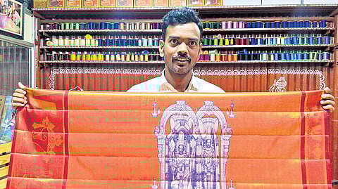Veldi Hariprasad, a weaver from Sircilla, with his silk saree or ceremonial cloth he wove for the upcoming Ram Navami festival
