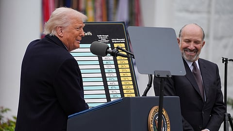 US President Donald Trump speaks during an event to announce new tariffs in the Rose Garden of the White House, Wednesday, April 2, 2025, in Washington, as Commerce Secretary Howard Lutnick listens.