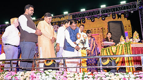 Chief Minister Mohan Charan Majhi lighting the lamp at the event.