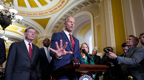 Senate Majority Leader John Thune, R-S.D., joined by Sen. John Barrasso, R-Wyo., the GOP whip, left, talks to reporters at the Capitol, in Washington, Tuesday, April 1, 2025.
