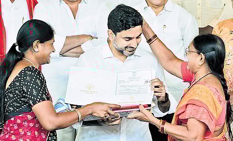 Residents of Mangalagiri blessing HRD and IT Minister Nara Lokesh after receiving house site pattas at Don Bosco School in Yerrabalem on Monday