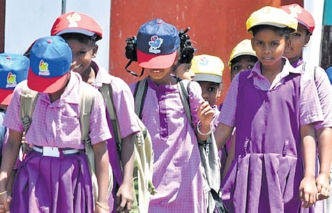 Schoolkids wearing caps on a hot sunny day in Vijayawada