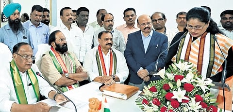 Council chairman Gutha Sukender Reddy administers the oath to M Vijayashanti.