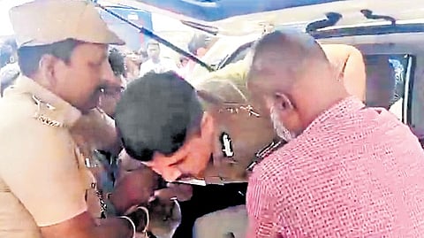 A video grab of the commissioner being rescued from the damaged car.